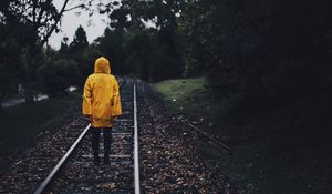 Preview wallpaper raincoat, man, railway, lonely, autumn, yellow