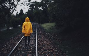 Preview wallpaper raincoat, man, railway, lonely, autumn, yellow