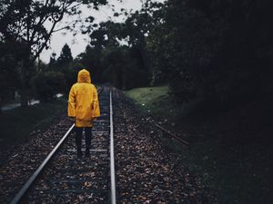 Preview wallpaper raincoat, man, railway, lonely, autumn, yellow