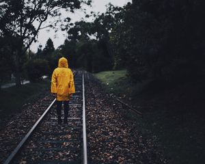 Preview wallpaper raincoat, man, railway, lonely, autumn, yellow