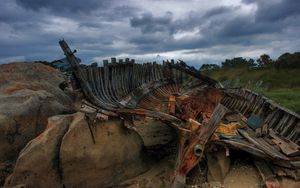 Preview wallpaper remains, boat, framework, stones, cloudy