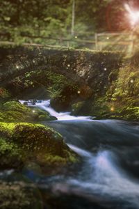 Preview wallpaper river, bridge, sunlight, flare, stones