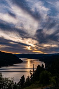 Preview wallpaper river, bridge, sunset, sky, clouds, trees