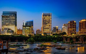 Preview wallpaper river, city, buildings, light, evening, dark