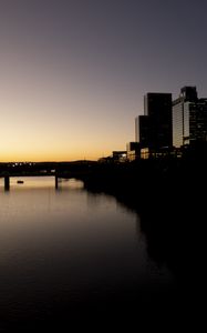 Preview wallpaper river, city, buildings, bridge, dark, shadows