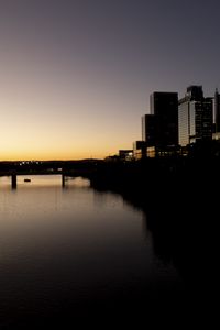 Preview wallpaper river, city, buildings, bridge, dark, shadows