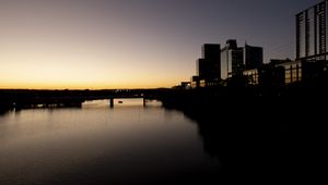 Preview wallpaper river, city, buildings, bridge, dark, shadows