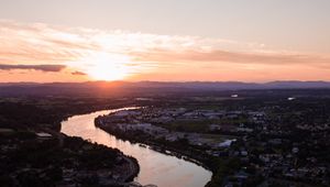 Preview wallpaper river, city, sunset, roofs