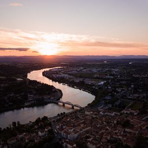 Preview wallpaper river, city, sunset, roofs