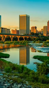 Preview wallpaper river, greens, bridge, buildings, city, sunset