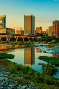 Preview wallpaper river, greens, bridge, buildings, city, sunset
