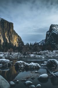 Preview wallpaper river, mountains, stones, shore, trees, cold, snowy