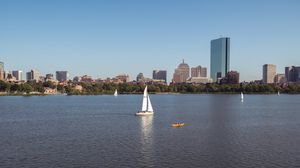 Preview wallpaper river, sail, boat, trees, buildings, city