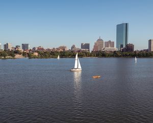 Preview wallpaper river, sail, boat, trees, buildings, city