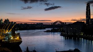 Preview wallpaper river, ship, bridge, city, sunset, dark