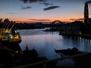 Preview wallpaper river, ship, bridge, city, sunset, dark