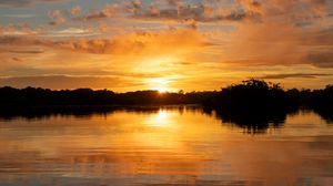 Preview wallpaper river, sunset, trees, silhouettes, clouds
