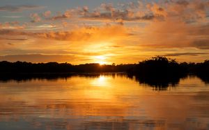 Preview wallpaper river, sunset, trees, silhouettes, clouds