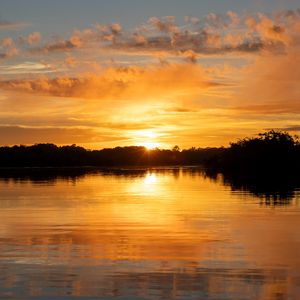 Preview wallpaper river, sunset, trees, silhouettes, clouds