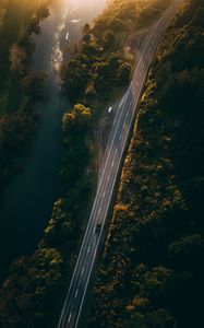 Preview wallpaper road, aerial view, river, rays, trees