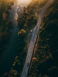 Preview wallpaper road, aerial view, river, rays, trees