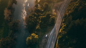 Preview wallpaper road, aerial view, river, rays, trees