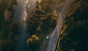 Preview wallpaper road, aerial view, river, rays, trees