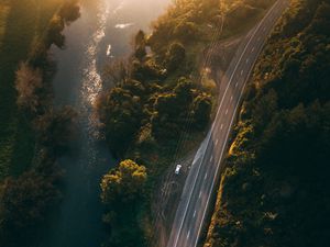 Preview wallpaper road, aerial view, river, rays, trees