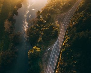 Preview wallpaper road, aerial view, river, rays, trees
