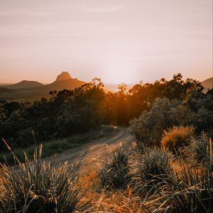 Preview wallpaper road, asphalt, mountains, grass