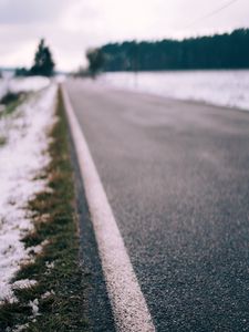 Preview wallpaper road, asphalt, snow, blur