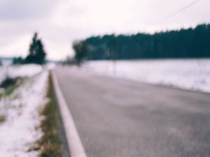 Preview wallpaper road, asphalt, snow, blur