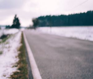 Preview wallpaper road, asphalt, snow, blur