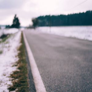 Preview wallpaper road, asphalt, snow, blur