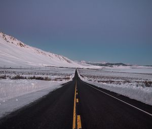 Preview wallpaper road, asphalt, snow, winter, horizon, direction