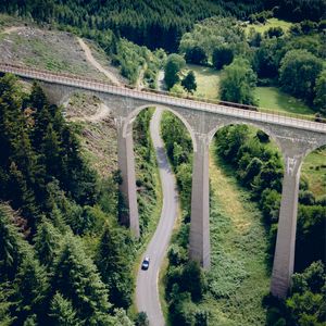 Preview wallpaper road, bridge, trees, forest, car