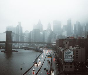 Preview wallpaper road, buildings, aerial view, city, fog