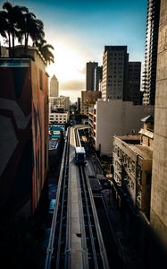 Preview wallpaper road, buildings, facades, car, palm trees