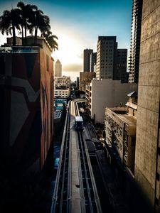 Preview wallpaper road, buildings, facades, car, palm trees