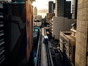 Preview wallpaper road, buildings, facades, car, palm trees