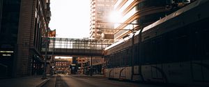 Preview wallpaper road, buildings, train, city, rays