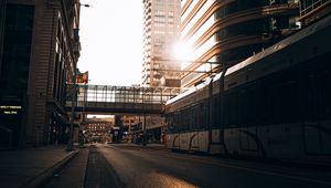 Preview wallpaper road, buildings, train, city, rays
