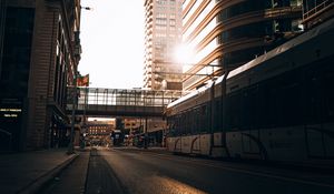 Preview wallpaper road, buildings, train, city, rays
