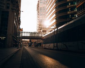 Preview wallpaper road, buildings, train, city, rays