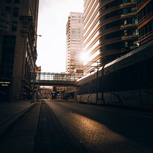 Preview wallpaper road, buildings, train, city, rays