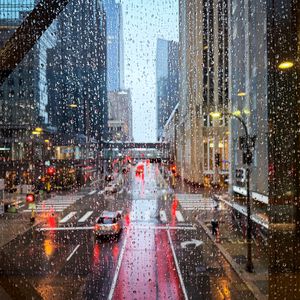 Preview wallpaper road, buildings, window, drops, rain, city