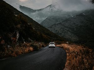 Preview wallpaper road, car, mountains, fog, clouds