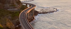 Preview wallpaper road, cars, bends, sea, aerial view