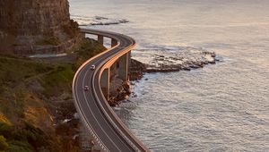 Preview wallpaper road, cars, bends, sea, aerial view