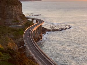 Preview wallpaper road, cars, bends, sea, aerial view